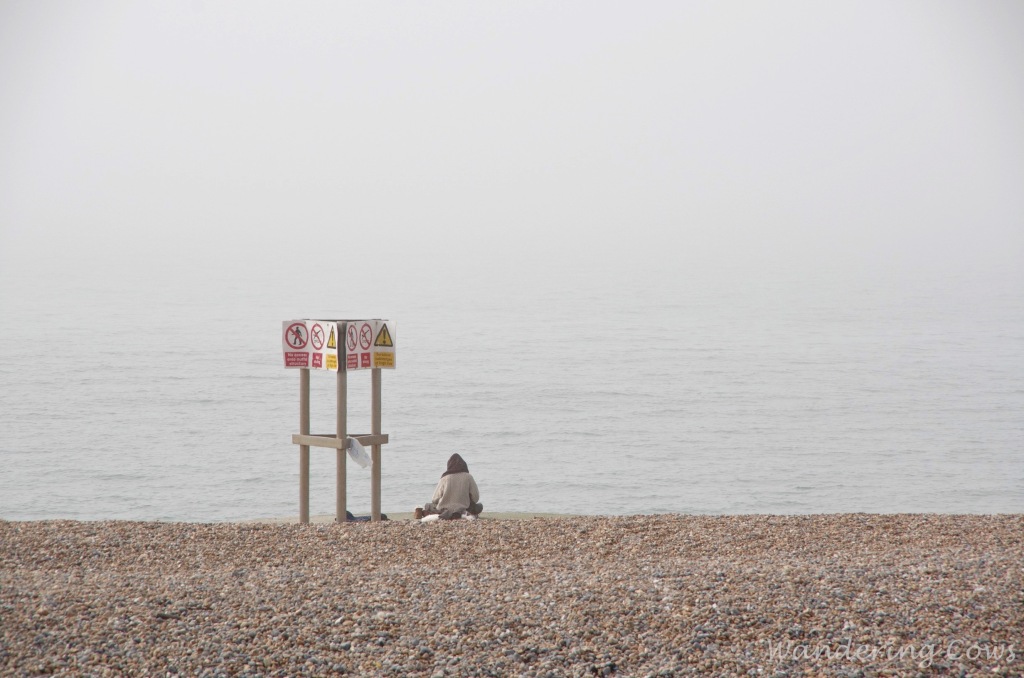 Sitting on the beach in the mist